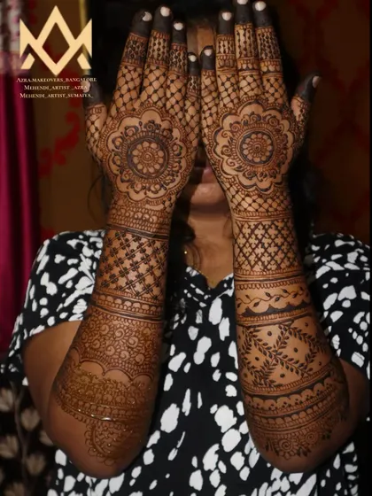 A client showing off her beautiful non-bridal mehendi, featuring mandalas and intricate arm work.