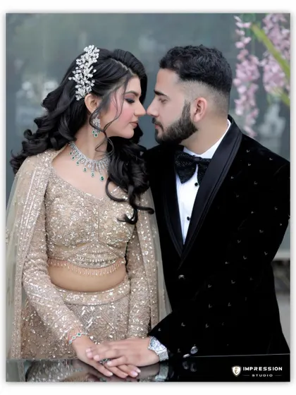 A moment of quiet connection before they look at the camera. This intimate portrait, with their foreheads nearly touching, captures the deep bond and understanding they share.