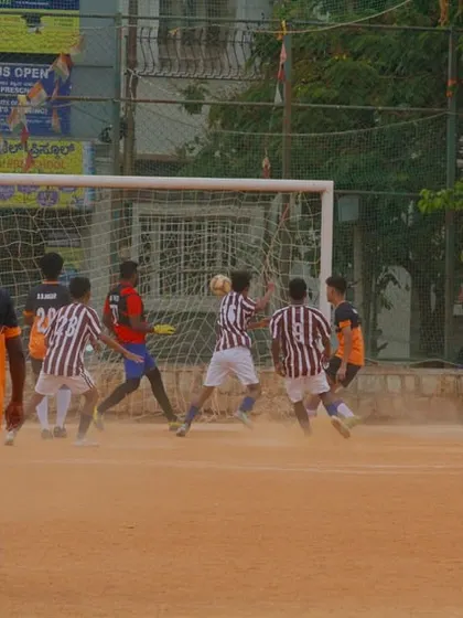 Action from our C-Division match. Players battle for the ball in front of the goal, showing the grit required to compete at this level.