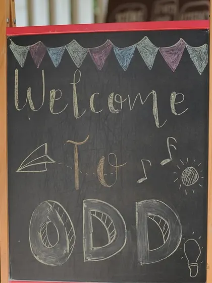 A welcome sign on a chalkboard easel, inviting children and families into our creative space.
