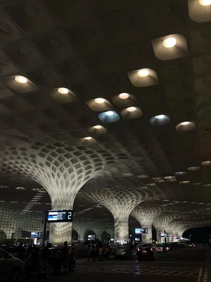 The stunning interior architecture of Mumbai's Chhatrapati Shivaji Maharaj International Airport (T2), with its unique peacock-feather inspired roof design.