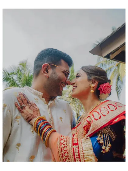 A close-up, happy moment between a couple during their traditional ceremony in Goa, showcasing their joy and the vibrant details of their attire.