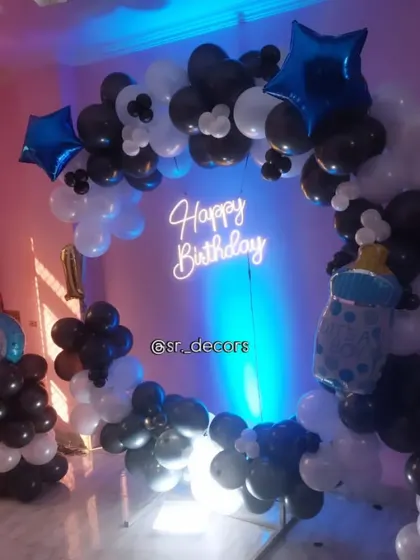 A full view of the black and white balloon ring, a versatile setup for a boy's first birthday or any modern celebration.