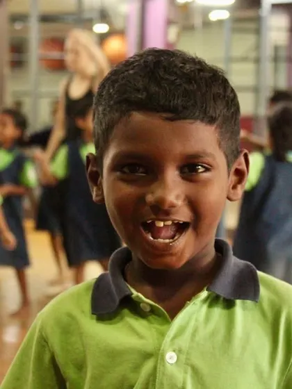 A close-up of a student's bright, happy face during our outreach class. These smiles are the reason we do what we do.