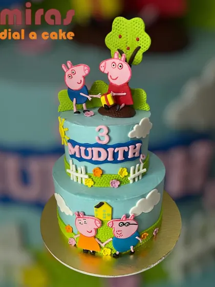 Oink oink! This delightful two-tier Peppa Pig cake brings the whole family together for a fun celebration. With green fields, a little house, and the whole Pig family, it's a perfect scene from the beloved show.