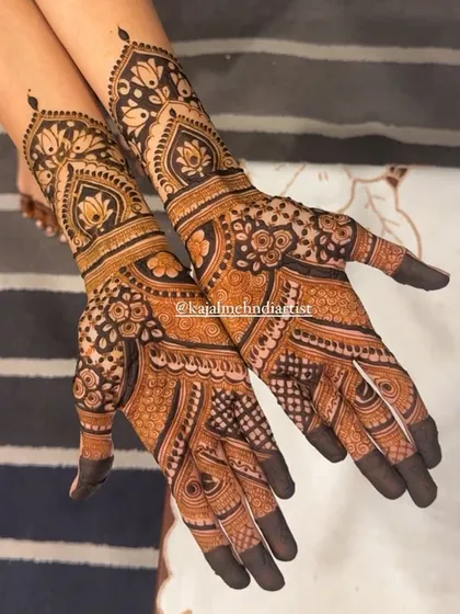This non-figurative Indian henna is filled with rich texture and patterns. The design uses a combination of paisleys, florals, and geometric fills to create a dense and captivating look.