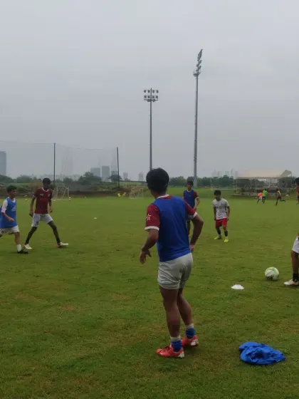 A group of players engaged in a possession based drill, learning to work together to keep the ball and create space.