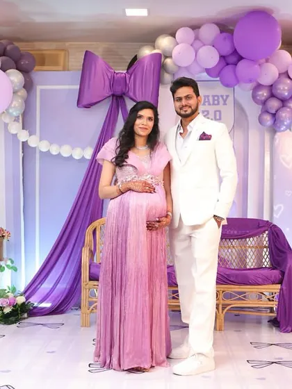 The happy couple at their bow-themed baby shower. I always coordinate with my clients to ensure the decor complements their outfits.