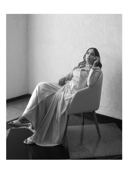 A chic, black and white portrait of the bride in a relaxed, elegant pose. This shot has a timeless, editorial quality.