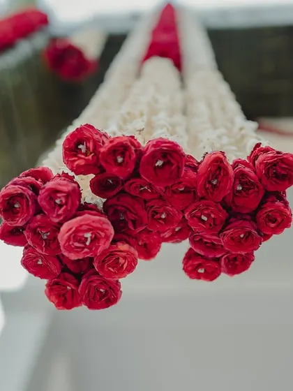 Hanging garlands made of red rose buds.
