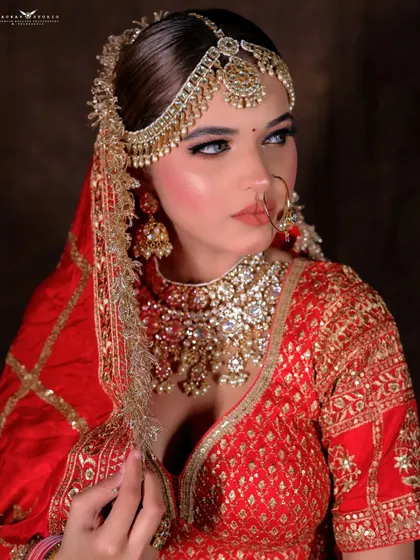 A striking profile shot of the bride looking away. This angle highlights her jawline, the elegant hairpiece, and the side details of her jewellery.