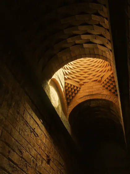 Another perspective of the brick dome, showing how the light from the oculus washes over the textured surfaces. The mathematical beauty of the structure creates a sense of rhythm and harmony.