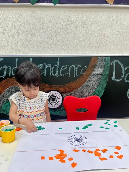 Another one of our little caterpillars busy with the Independence Day flag craft. These hands-on activities make learning about our nation's heritage engaging and memorable.