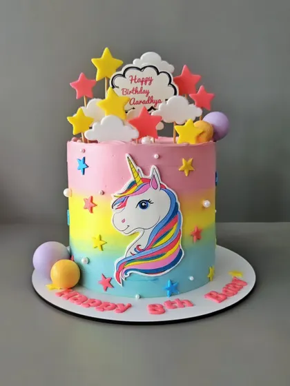 A magical unicorn cake for Aaradhya's 8th birthday. This colorful cake combines a unicorn theme with rainbows and stars, perfect for a little girl's dream party.