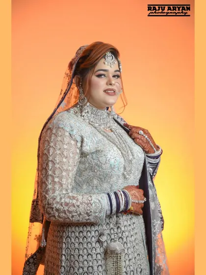 A direct and engaging portrait with the warm orange backdrop. The bride's confident expression and beautiful smile make this a standout shot.