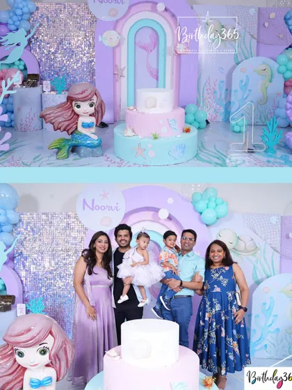 A lovely family photo from Noorvi's Little Mermaid-themed first birthday, set against a shimmering backdrop and pastel-colored decor.