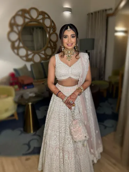 Reimagining the modern Indian princess for Vasvi's engagement. Her stunning features shine with a winged liner for regal eyes and soft pink hues on the cheeks and lips.
