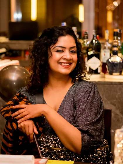 A warm, smiling portrait of a guest seated at her table during a birthday dinner. Our goal is to capture the happy and relaxed atmosphere of your event through the faces of your friends and family.