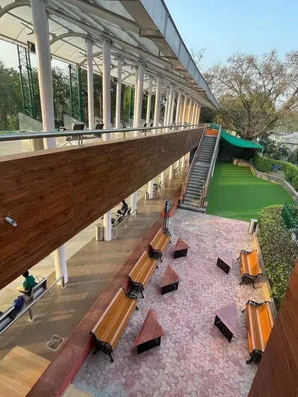 A high-angle view showcasing our two-tier structure and the putting and chipping green below. We offer facilities for every aspect of your game.