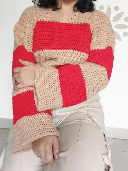 This is my Cotton Candy Sweater, featuring bold red and beige stripes and dramatic bell sleeves for a retro-inspired look.