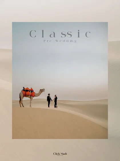 A classic pre-wedding portrait in the Rajasthan desert, featuring the couple and a camel against an endless horizon, creating a timeless and cinematic feel.