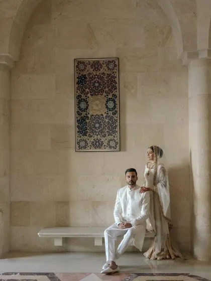A formal portrait of the couple at the Ismaili Centre, exuding a sense of calm and regal elegance.