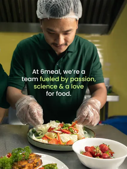 We are a team fueled by passion, science, and a love for food. Here, one of our chefs is carefully plating a salad, ensuring it's not only nutritious but also beautiful.