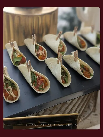 Another view of my popular mini tacos, presented on a sleek black slate platter. The presentation is as important as the taste, and I ensure every detail is perfect.