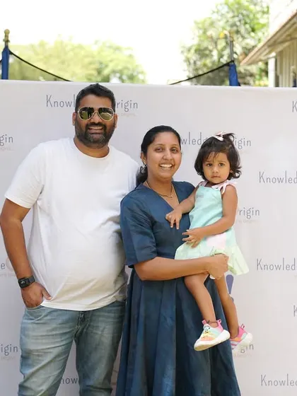 A family poses together at a school event, highlighting the importance we place on family involvement.