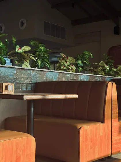 We designed these comfortable booth seating areas to offer a sense of privacy while maintaining the open feel of the restaurant. The warm tan leather upholstery is complemented by a divider wall with blue-green tiles and lush planters.
