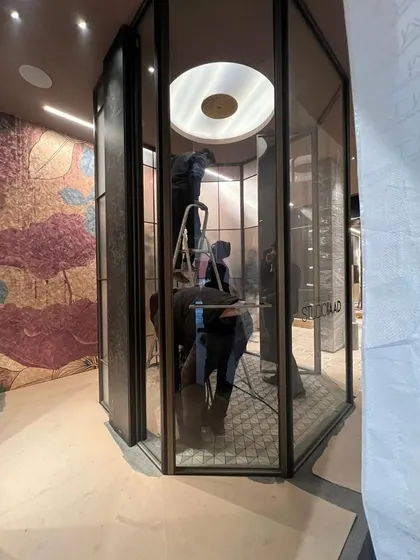 A behind-the-scenes look at the construction of the WALTZ 2024 exhibit. This image shows the intricate process of assembling the central glass shower cubicle, highlighting the precision and teamwork required to bring our designs to life.