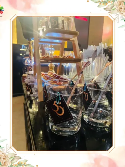 A detailed view of the bar setup for a 50th birthday at Sahara Star, Mumbai, showcasing custom glassware and appetizers.