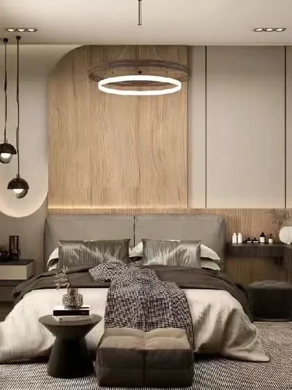 A calm and contemporary bedroom featuring a circular pendant light and a wood-paneled accent wall. The design includes a floating vanity table and a full-length oval mirror.