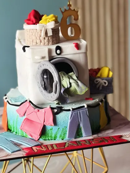 Who knew laundry could be this sweet? This unique washing machine cake, complete with tiny clothes and laundry baskets, was a fun and quirky creation for a 6th birthday.