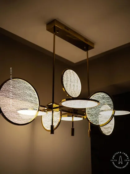 This artistic chandelier is composed of multiple circular discs with a unique woven texture. The layered arrangement and soft backlighting create a beautiful interplay of light and shadow, making it a captivating centerpiece.