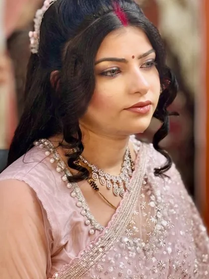 A soft and subtle makeup look for a party. The client is wearing a beautiful pink saree, and the makeup enhances her natural features without being too heavy.