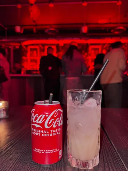 A close-up of my drinks, a classic Coca-Cola and a craft cocktail.