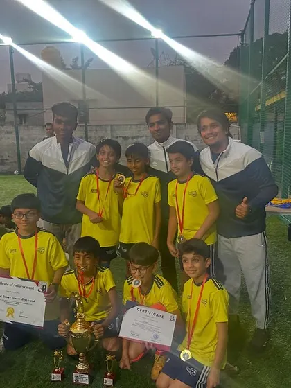 The Under-10 winners of the Samurai Cup with their coaches. A fantastic achievement that showcases their skill and teamwork.