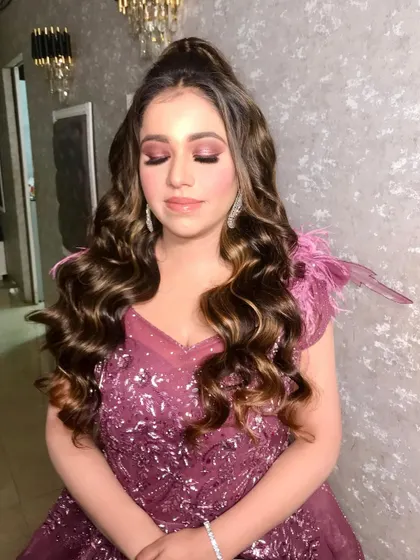 A beautiful shot of our client Anisha, dolled up for her engagement. We created a soft glam look with pink-toned eyeshadow and voluminous curls to match her stunning gown.