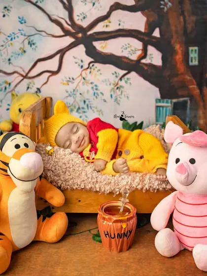 Another sweet shot from the Winnie the Pooh collection, with the baby sleeping on a tiny bed surrounded by friends from the Hundred Acre Wood.
