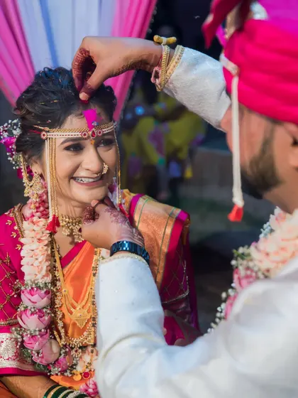 The groom applies sindoor to the bride's forehead, a beautiful and significant ritual symbolizing their marriage.