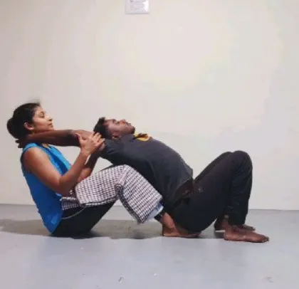Here I am on the other side, receiving the same assisted stretch. Experiencing the pose as a student is crucial for me to understand how to guide others effectively.