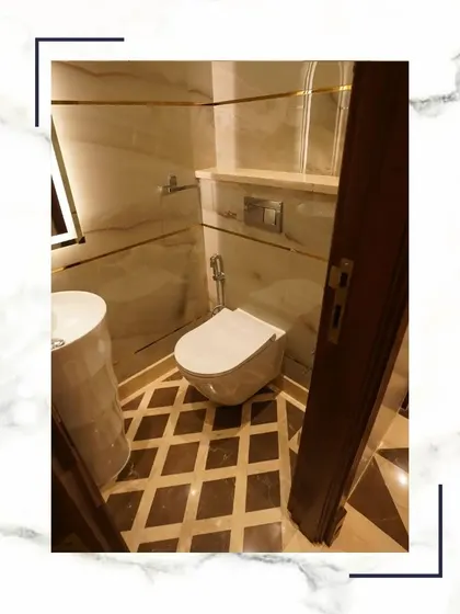 Indulge in opulence with a washroom that rivals a spa sanctuary. This compact yet luxurious space features beautiful tile work and high-end fixtures.