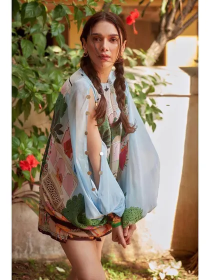 A playful and artistic look for Aditi Rao Hydari. This printed tunic and shorts set from Limerick is like wearable art. We styled it with fun pigtails to match the youthful vibe.