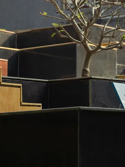 **Nepean Greens, Mumbai:** The geometric forms of the planters and steps create a strong visual language. A young tree planted within a platform signifies the integration of nature and the long-term vision for the space to grow with the community.