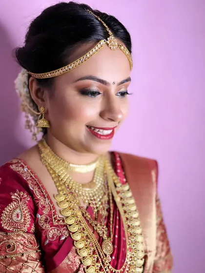 A side profile of this stunning South Indian bridal look. The makeup is designed to look flawless from every angle, with a focus on glowing skin and defined features.