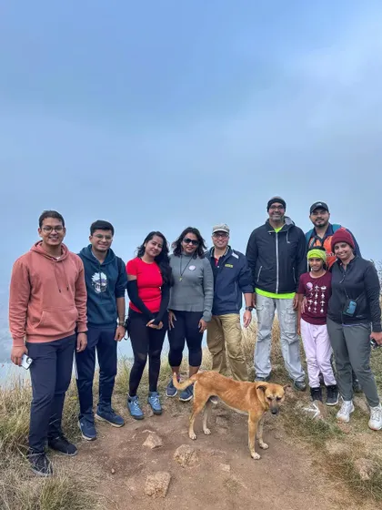 A group of friends and family, including a friendly stray dog, posing at the Makalidurga summit. Our treks are about enjoying nature with all its friendly inhabitants.