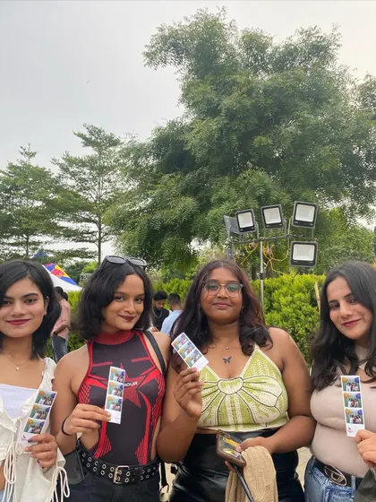 Four friends posing with their prints, showcasing their individual styles.