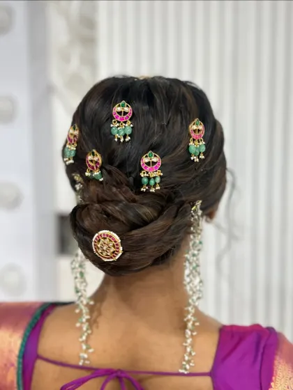 A close up of the temple jewellery on the textured bun, showing the detail of the accessories.