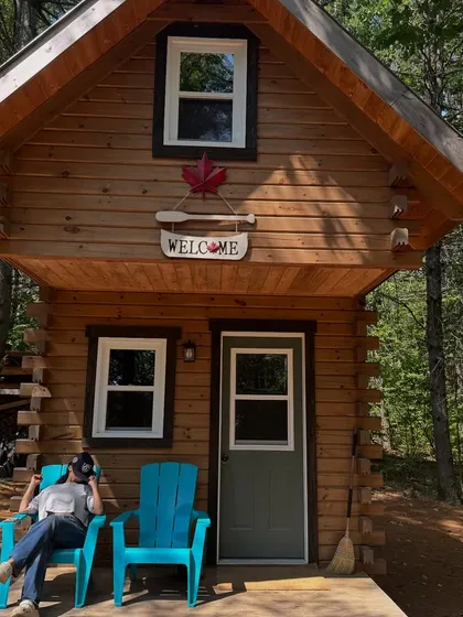 Relaxing outside a tiny cabin in the woods, a perfect getaway spot in Ontario.